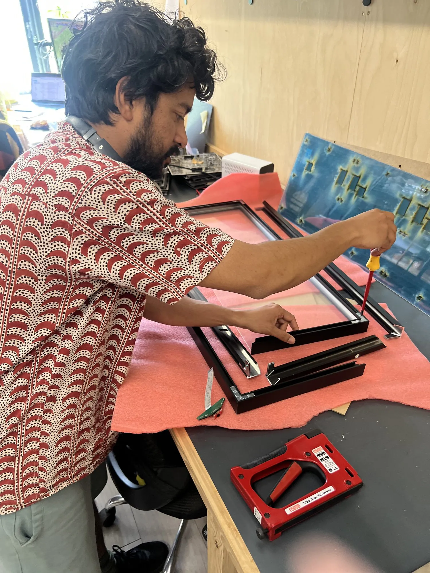 Dhruv Kumar assembling an LED panel at his bench