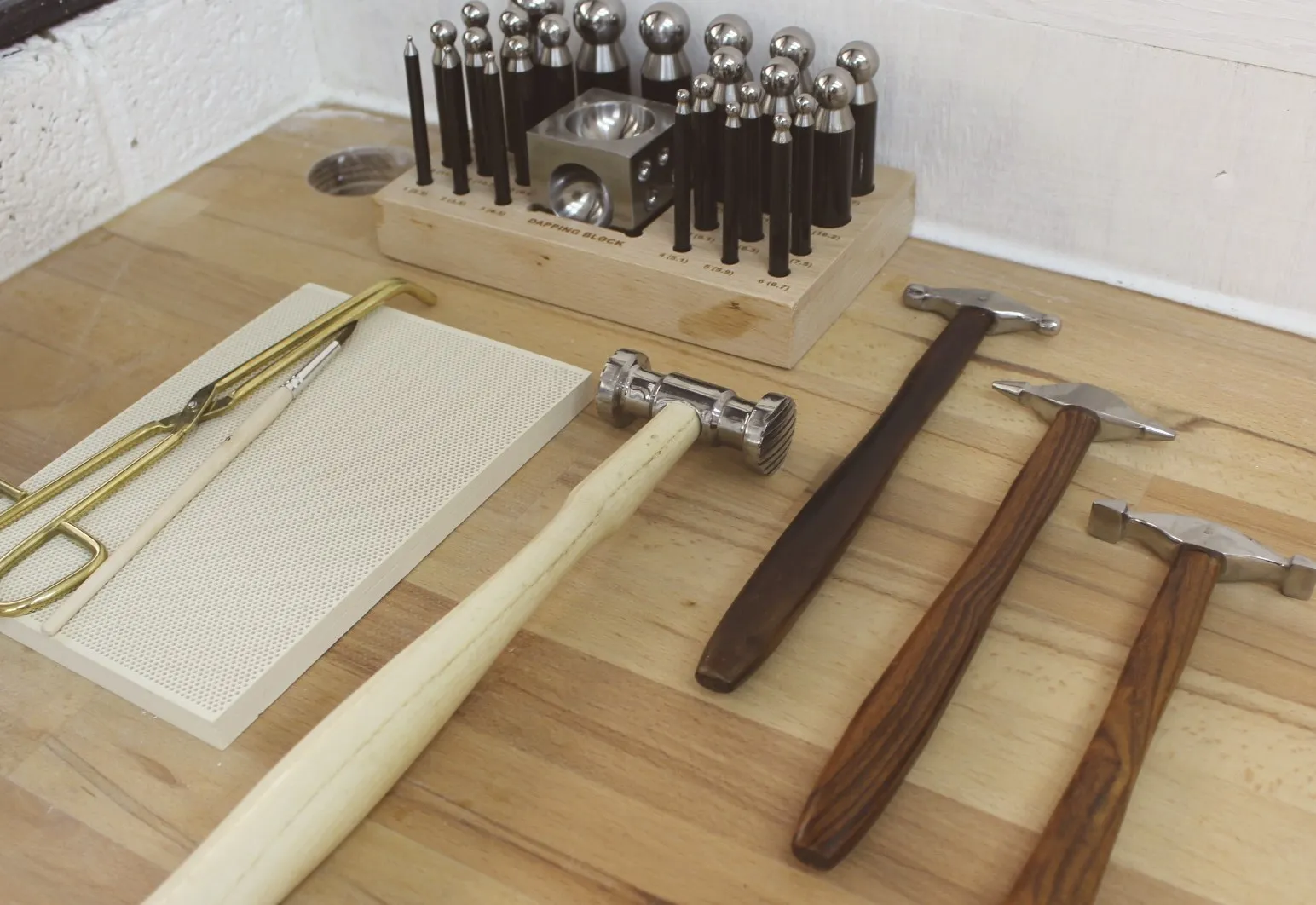 A doming block and hammers