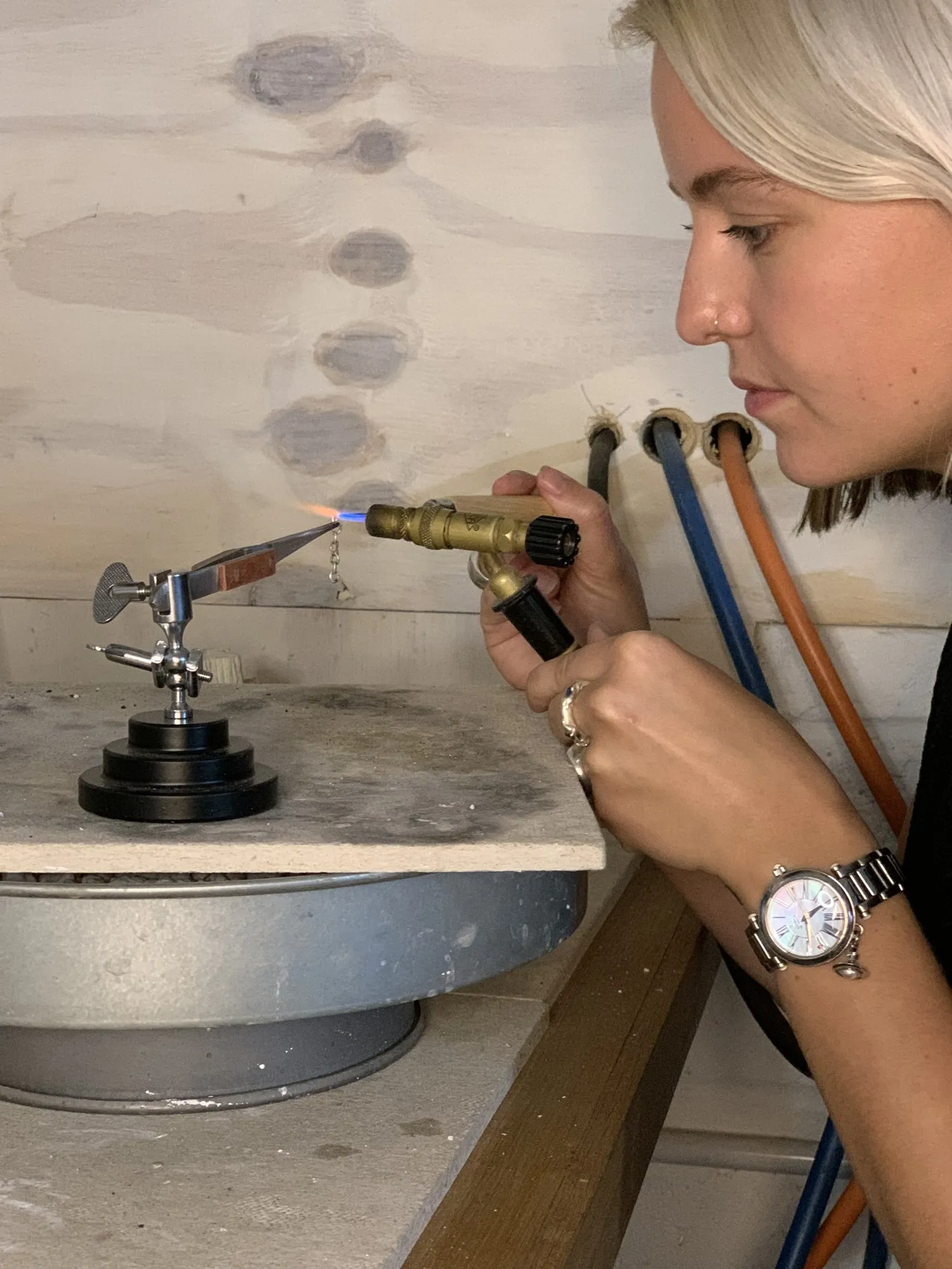 A jeweller soldering with a torch