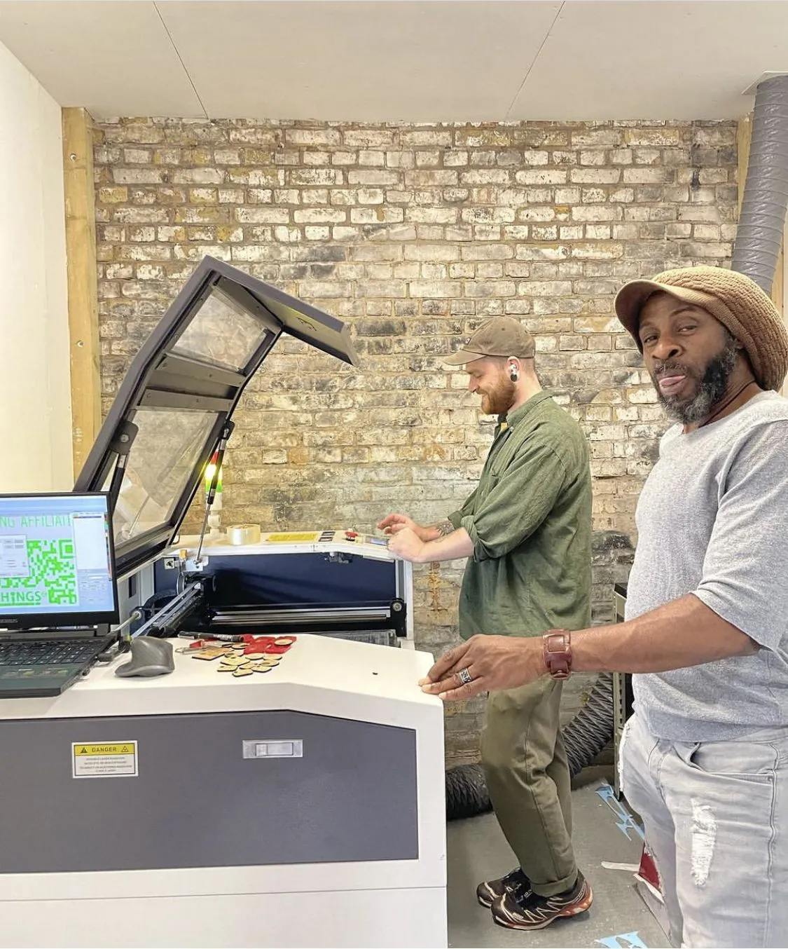 Two members at the Trotec laser cutter