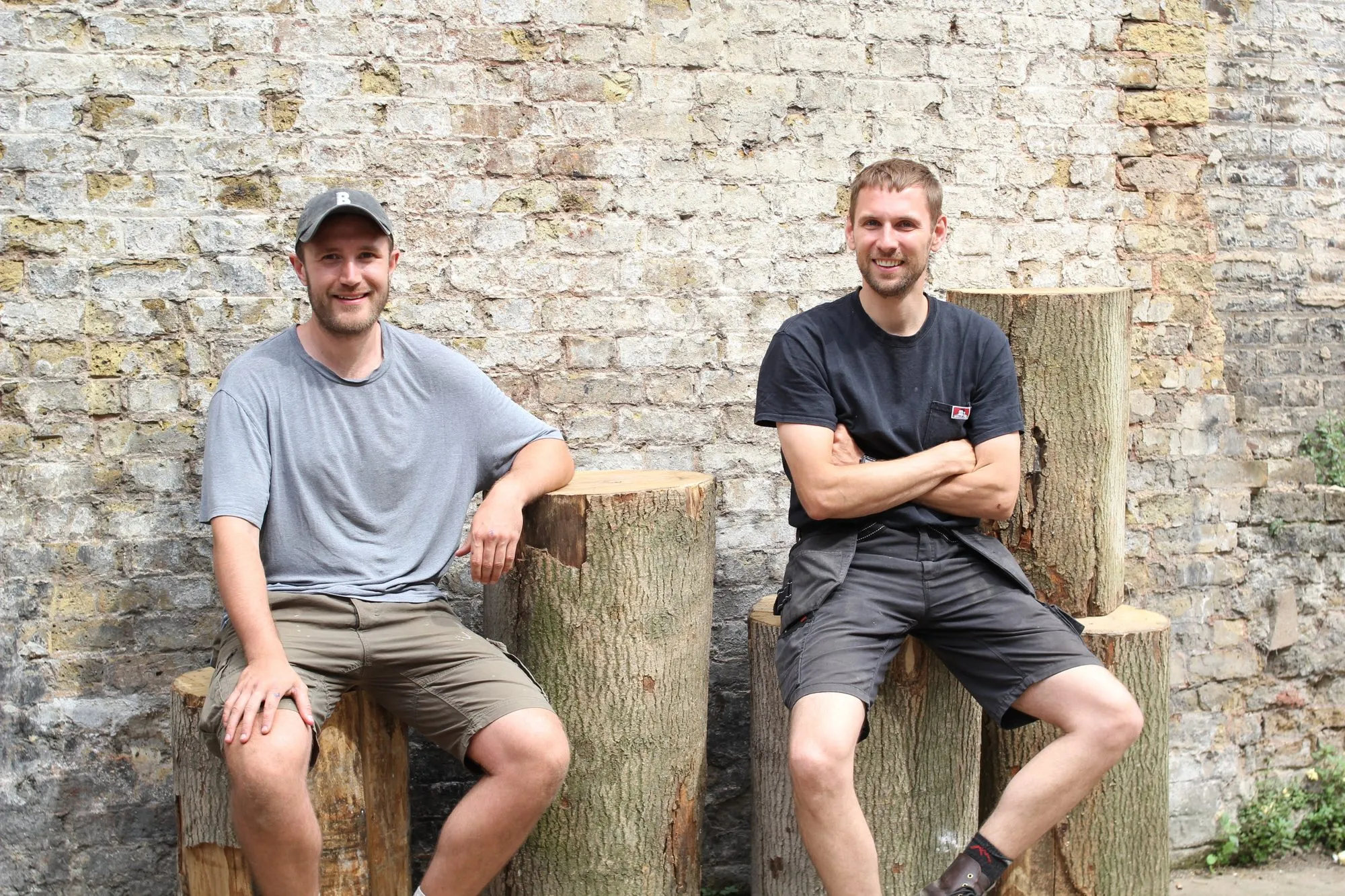 Two furniture makers on the logs in the yard at Hone Limehouse