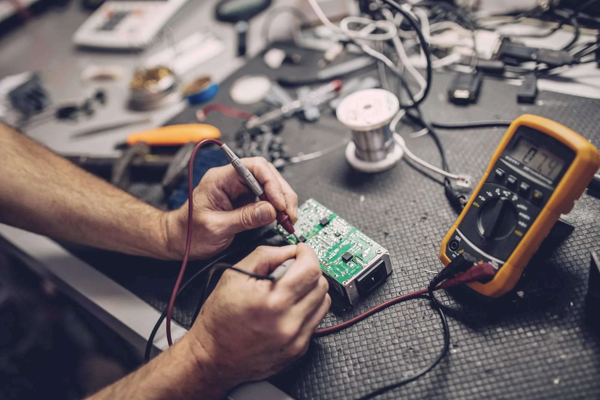 Testing a circuit board at the electronics bench
